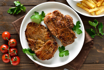 Homemade juicy grilled pork steaks on plate