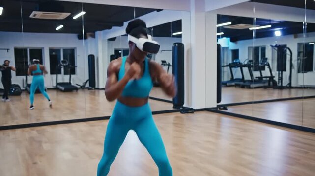 Woman boxing in gym wearing virtual reality headset fitness training