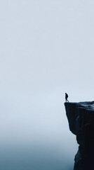 Solitary hiker cliff edge foggy sky contemplative