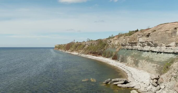 Aerial view of Pakri cliffs, a spectacular limestone coastal escarpment located on the Pakri Peninsula, in spring with clouds in the sky, Estonia.