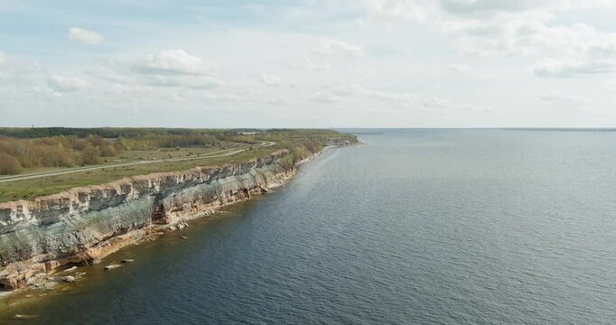 Aerial view of Pakri cliffs, a spectacular limestone coastal escarpment located on the Pakri Peninsula, in spring with clouds in the sky, Estonia.