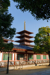 Osaka. Shitennoji. The Red Tower of the Japanese Temple-Pagoda with a Golden Spire Against a Clear Blue Sky, Historical Architecture