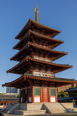 Osaka. Shitennoji. The Red Tower of the Japanese Temple-Pagoda with a Golden Spire Against a Clear Blue Sky, Historical Architecture