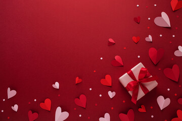 Saint Valentine day background with red and pink paper cut out hearts and gift box. Festive card for dating and romantic greeting.