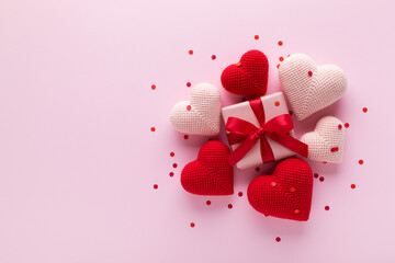 Gift box decorated with various love hearts on pink background. Valentine Day or Mother Day greeting card template.