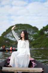 Close-up of a beautiful and lovely Asian woman taking a deep breath in a natural forest.