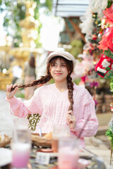  During Christmas time, a happy young woman enjoys a large Christmas gift.