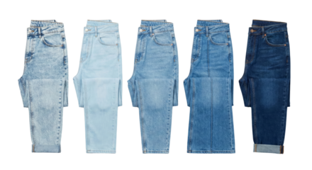 Collection of five different styles of denim jeans laid flat with isolated transparent background