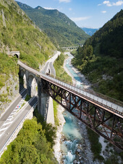 Alpine mountain valley with bridge and river at the Alpe Adria bicycle trail