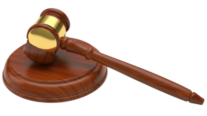 A wooden gavel with a gold head on a sound block