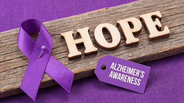 Purple ribbon pin on wood with Alzheimer's Awareness tag and Hope text. Dementia memory loss support, senior health care campaign and brain disease prevention concept on violet background
