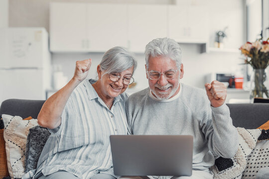 Excited senior couple, laptop and cheering in home for online shopping deal, sales and good news in lottery. Happy old man, woman and wow celebration on computer for winning, surprise and competition