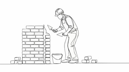 Bricklayer working on construction site building a wall.
