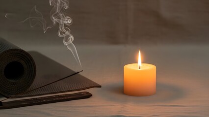 Peaceful meditation setting with rolled yoga mat, smoking incense stick, and glowing candle on a soft surface.