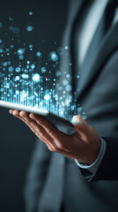 Business suit hand tablet digital data technology concept Modern business suit hand holding tablet with digital data concept, glowing hologram