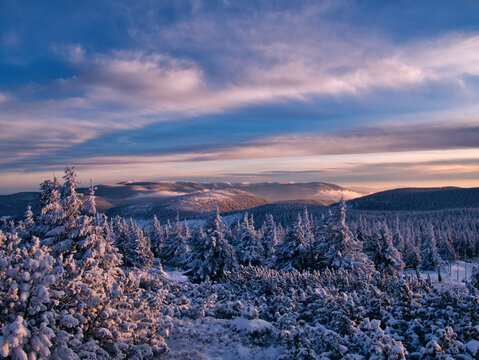 Beautiful harsh snow covered scenic landscape of a mountain range of Jeseniky mountains in late afternoon