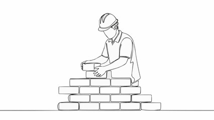 Construction worker building a brick wall with focus and precision. © Cihu