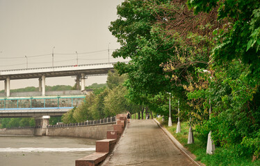 The Moskva River embankment. A wet pedestrian walkway after a summer rain