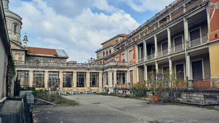 Abandoned hospital courtyard with classical architecture