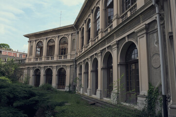 Abandoned hospital courtyard with classical architecture