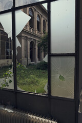 Abandoned hospital courtyard with classical architecture