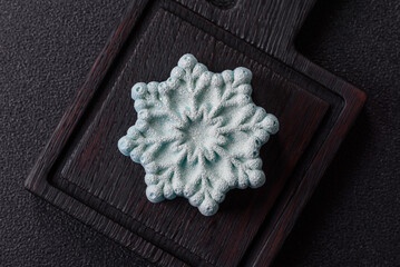 Fototapeta premium Christmas mochi, mooncake, or cheesecake shaped like a snowflake. Christmas mochi or cheesecake