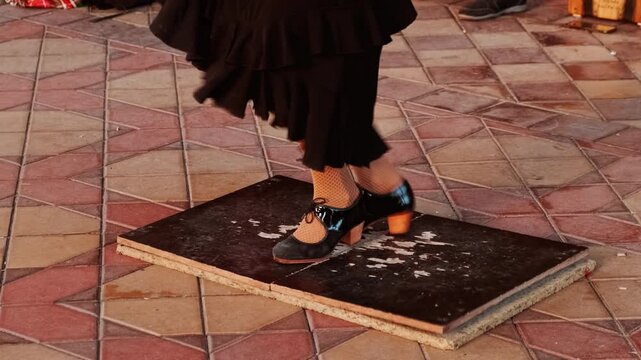 Flamenco shoes of a dancer performing footwork known as zapateado on an improvised tablao in Plaza de Espana, Seville, Andalusia, Spain