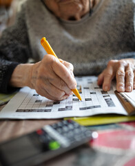 Solving a crossword puzzle with a mobile phone nearby