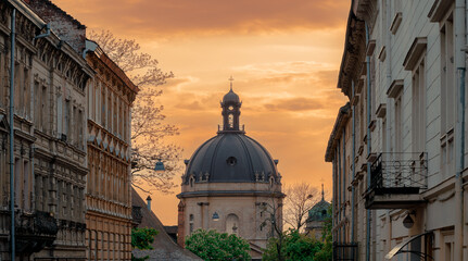 dramatic historical city scape central Europe aesthetic urban landmark famous place view on catholic church dome old building facade and sunset evening dusk sky background panoramic