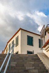 View of a two-story masonry building from below. Building infrastructure in a mountainous area