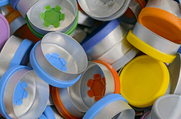 A variety of different colored caps for medicine bottles