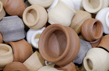 A variety of small toy clay pots of various sizes and colors