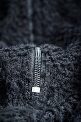 Zipper on black fleece background close-up