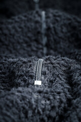 Zipper on black fleece background close-up