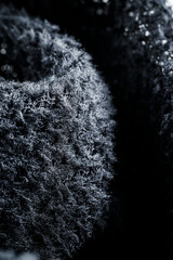 The fabric of black fleece, a synthetic knit with a soft, fluffy texture