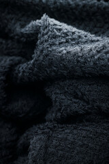 Texture of black fleece, shaggy high-tech synthetic knit