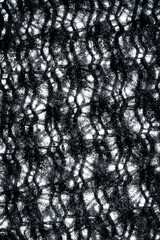 The texture of a soft black fleece fabric with visible fibers and folds