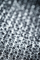 The fabric of black fleece, a synthetic knit with a soft, fluffy texture