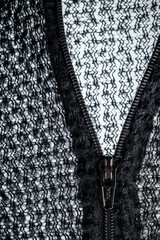 Zipper on black fleece background close-up