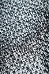 The texture of a soft black fleece fabric with visible fibers and folds