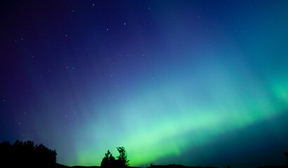 Northern Lights_ripples of green lights shining in blue and purple sky