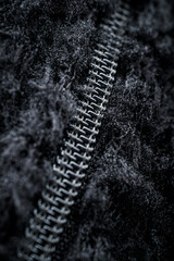 Zipper on black fleece background close-up
