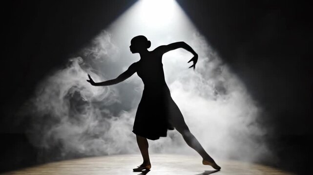 Female dancer performing elegant ballet moves as a silhouette under a dramatic spotlight with smoke for artistic expression concept and theatrical show