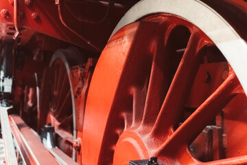 Exploring the intricate details of a vintage steam locomotive wheel at a historic railway site