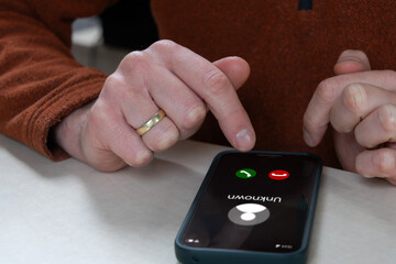 Person Making Decission WhetherTo Answer Unknown Call On Smartphone Or To Decline. Spam Scam Warning, Call Screening And Block Security Controls To Stop Robocall Fraud, Protect Contacts And Privacy