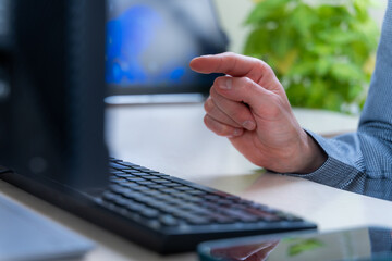 Pointing Finger Signals Decision And Selection At Office Keyboard Computer Workflow, Focus Planning For Next Action In Digital Work, Review Meeting And Task Priorities