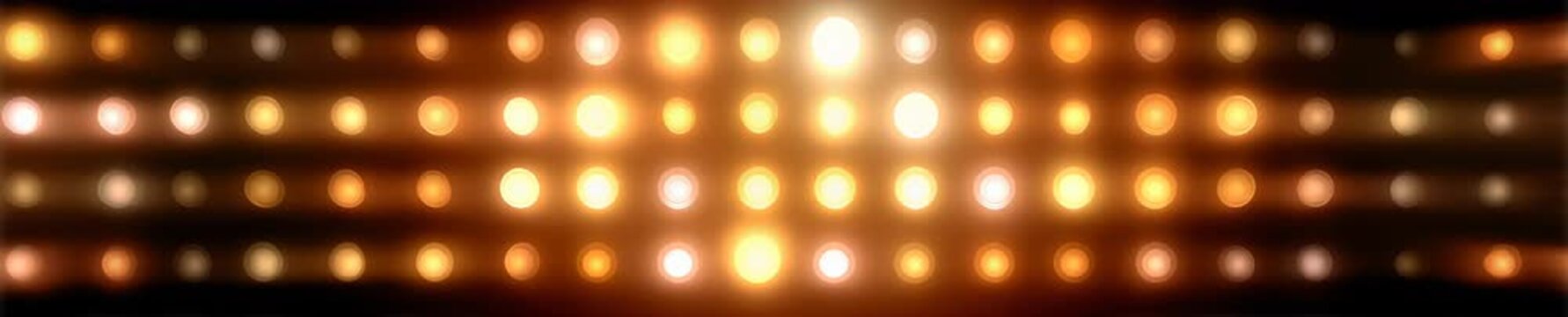 Wall of flashing round incandescent light bulbs on black background. Retro stage lighting grid video background, banner. 