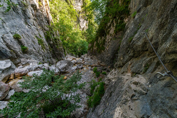 Obraz premium Adventure Awaits on Hvadnik Via Ferrata Through Martuljek Gorges Dramatic Rocky Pathways