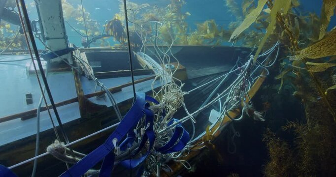 Dangerous lines and straps cover recent sunken sailboat.
