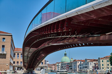 Tourist walking through narrow Venetian streets contemplating the scenic canals and traditional gondolas in Venice Italy